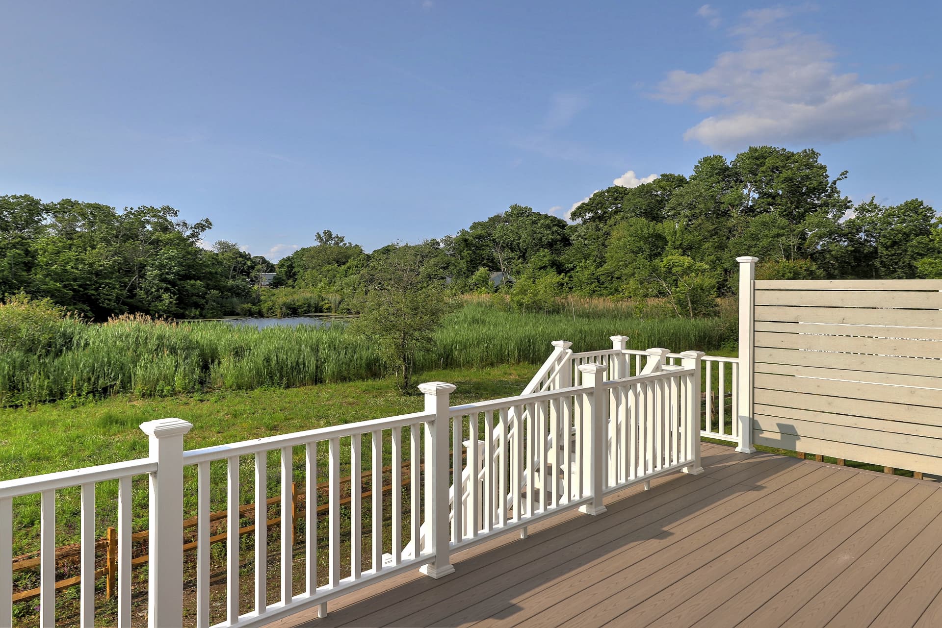 Deck view over the marsh to the pond